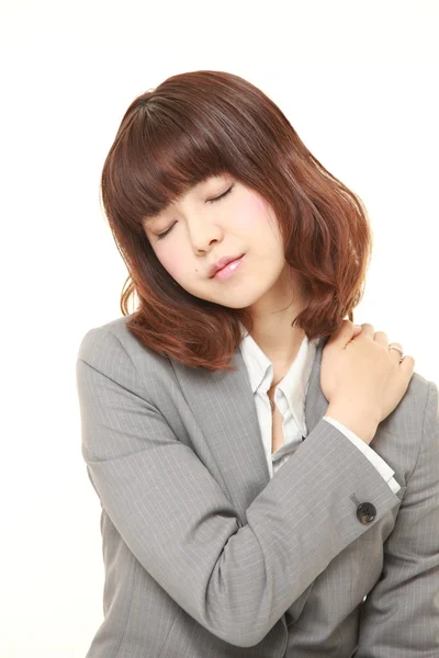 Japanese businesswoman suffers from neck ache — Stock Photo, Image