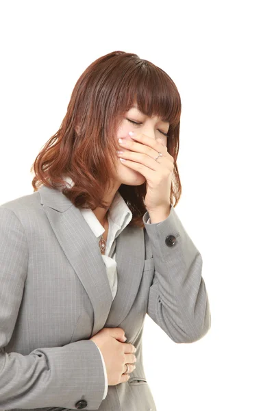 Joven japonesa mujer de negocios se siente como vomitar — Foto de Stock