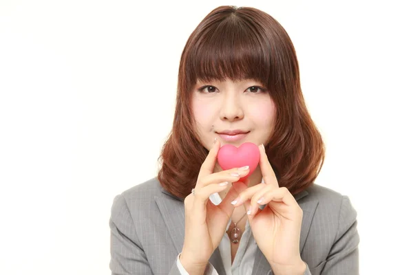 Japanese businesswoman with heart — Stock Photo, Image