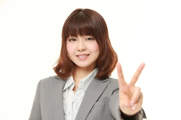 Young Japanese Businesswoman showing a victory sign — Stock Photo, Image