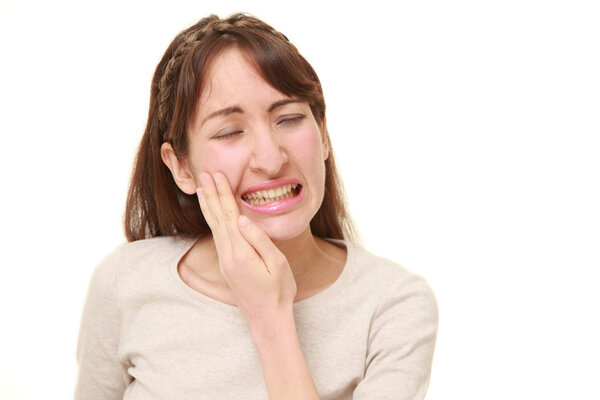 young woman suffers from toothache