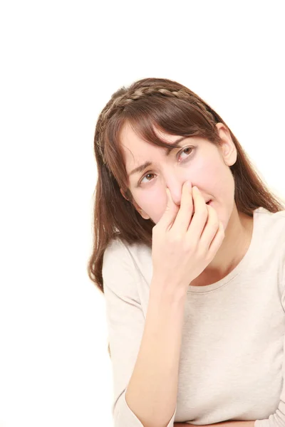 Woman holding her nose because of a bad smell — Stock Photo, Image