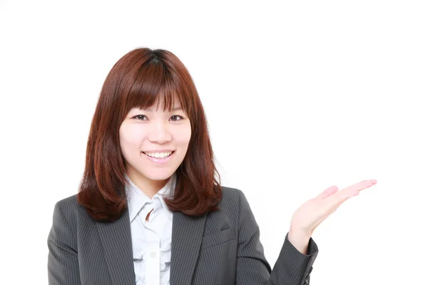 Joven mujer de negocios japonesa presentando y mostrando algo —  Fotos de Stock