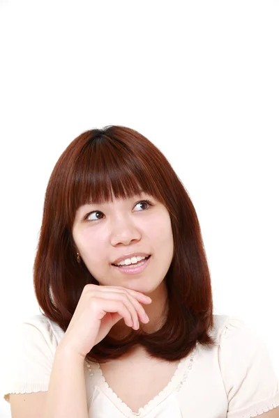 Young Japanese woman thinks about something — Stock Photo, Image