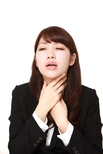 Young Japanese businesswoman having throat pain — Stock Photo, Image