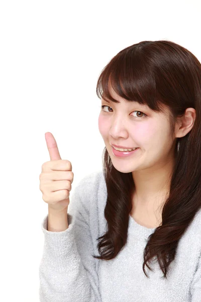 Νέα ιαπωνική γυναίκα με μπράβο χειρονομία — Φωτογραφία Αρχείου