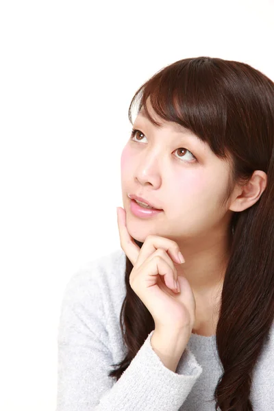 Young Japanese woman thinks about something — Stock Photo, Image