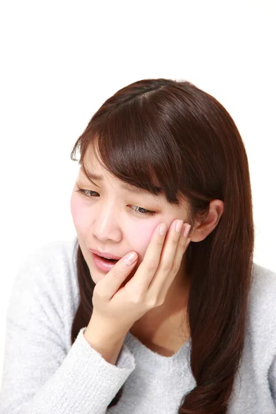 Young Japanese woman suffers from toothache — Stock Photo, Image