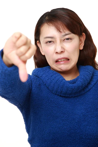 Asian woman with thumbs down gesture — Stock Photo, Image