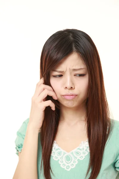 Young Japanese woman worries about something — Stock Photo, Image