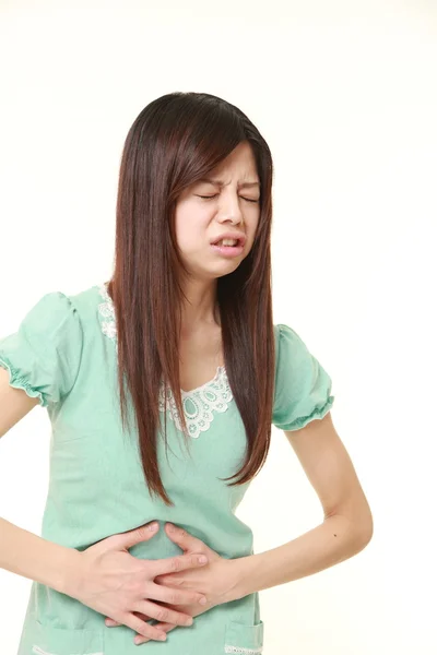 Jovem mulher japonesa sofre de dor de estômago — Fotografia de Stock