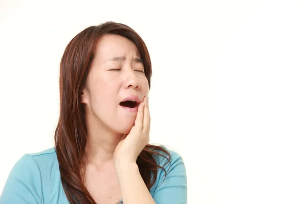 Middle aged Japanese woman suffers from toothache — Stock Photo, Image