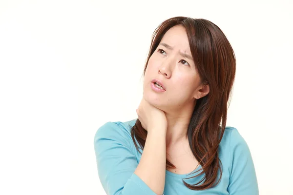 Middle aged Japanese woman suffers from neck ache — Stock Photo, Image