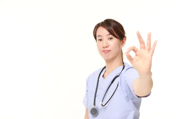 Japanese female doctor showing perfect sign — Stock Photo, Image