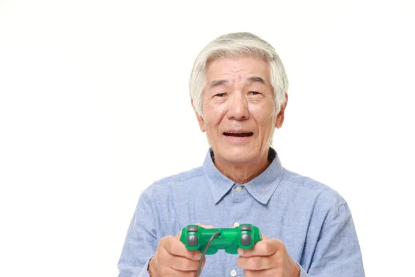 Senior Japanese man losing playing video game — Stock Photo, Image