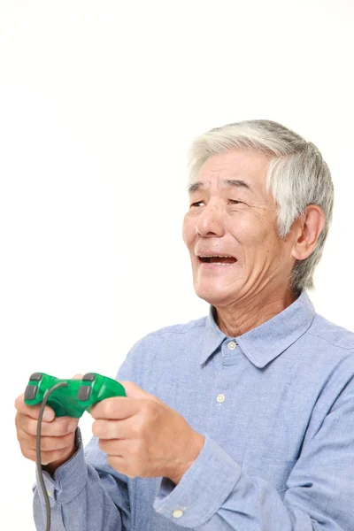 Senior Japanese man losing playing video game — Stock Photo, Image