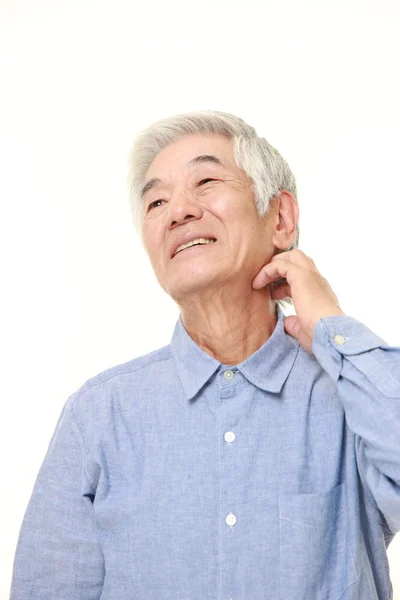 Senior Japanese man scratching his neck — Stock Photo, Image