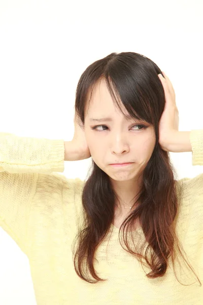 Young Japanese woman suffers from noise — Stock Photo, Image