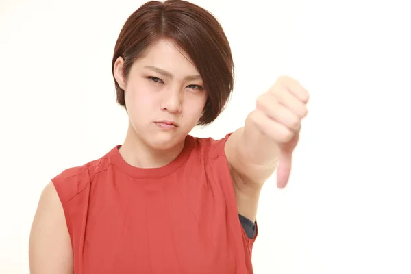 Young Japanese woman with thumbs down gesture — Stock Photo, Image