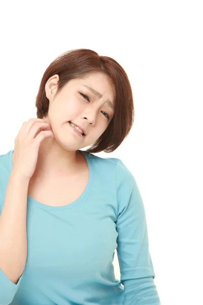 Japanese woman scratching her neck — Stock Photo, Image