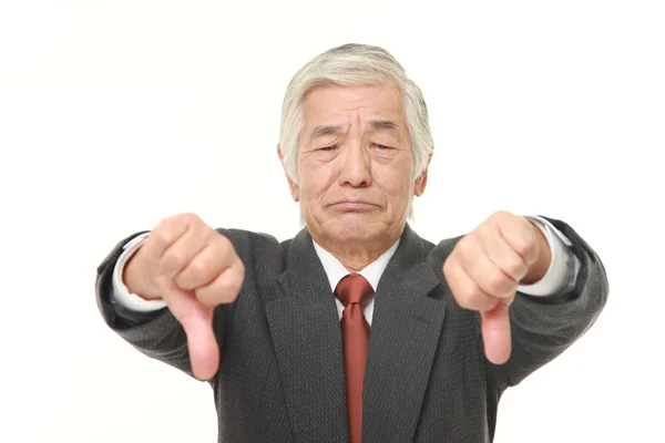 Senior Japanese businessman with thumbs down gesture — Stock Photo, Image