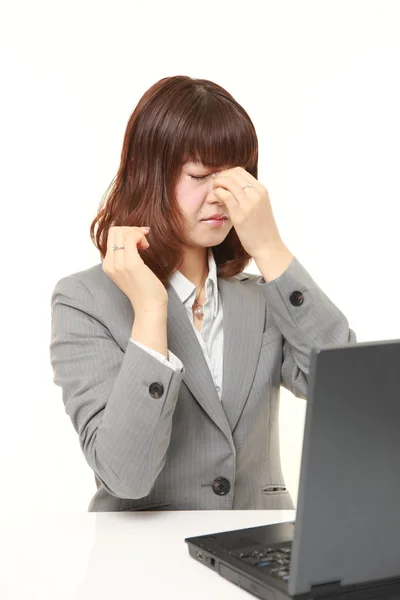 Young Japanese businesswoman suffers from Asthenopia — Stock Photo, Image