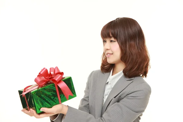 Junge japanische Geschäftsfrau bietet ein Geschenk an — Stockfoto