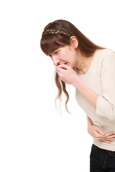 Молодая женщина чувствует себя vomiting — стоковое фото