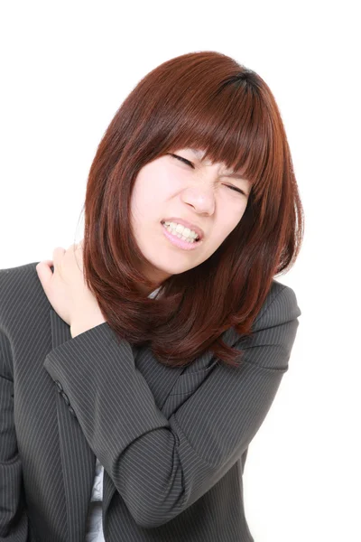 Japanese businesswoman suffers from neck ache — Stock Photo, Image