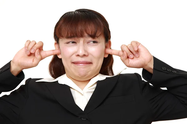 Asian businesswoman suffers from noise — Stock Photo, Image