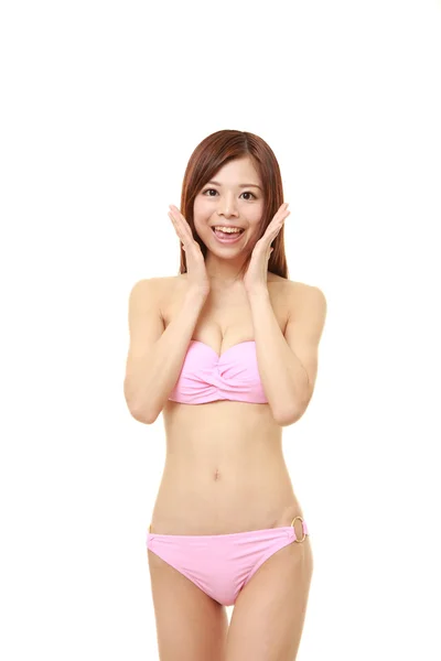 Young Japanese woman in a pink bikini pleased — Stock Photo, Image