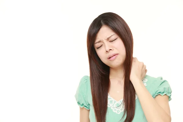 Young Japanese woman suffers from neck ache — Stock Photo, Image