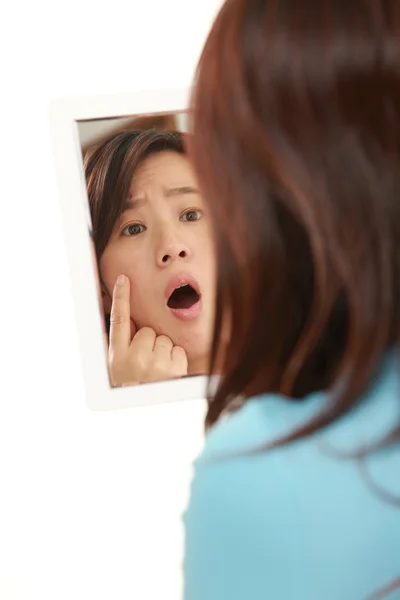 Mujer japonesa de mediana edad se preocupa por la piel seca áspera — Foto de Stock