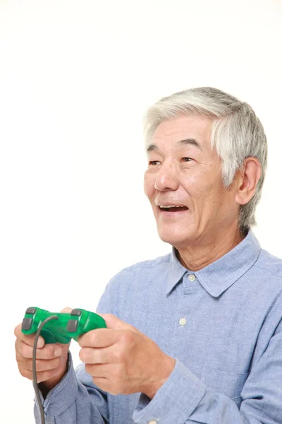 Senior Japanese man enjoying a video game — Stock Photo, Image