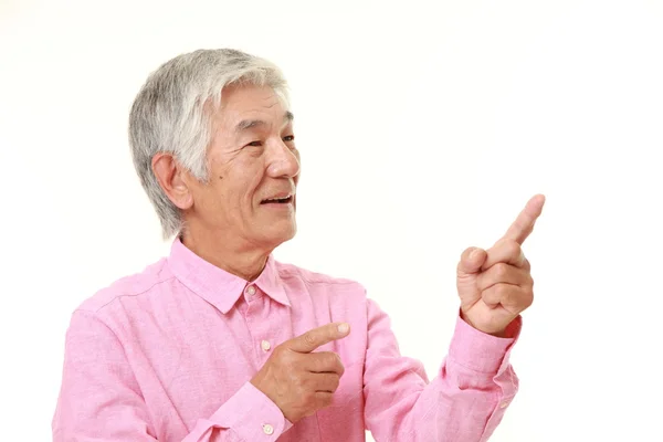 Senior Japanese man presenting and showing something — Stock Photo, Image