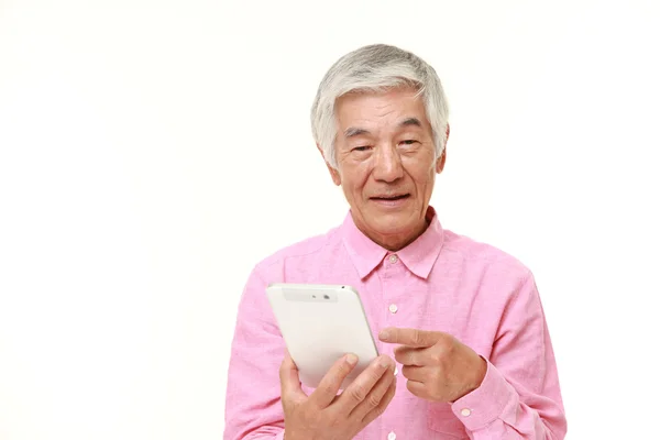 Старший японский человек с помощью планшетного компьютера — стоковое фото