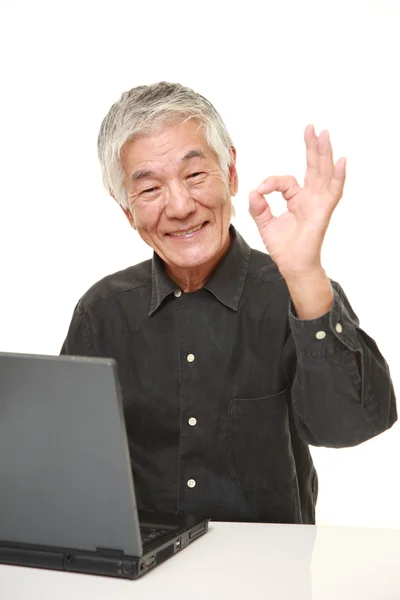 Старший японский человек с помощью ноутбука — стоковое фото