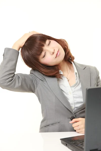 Young businesswoman doing self neck stretch — Stock Photo, Image