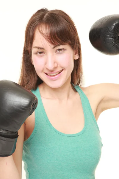 Female boxer with punching glovesthrows in a victory pose — Stock Photo, Image