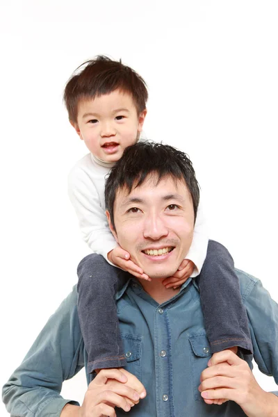 Japanese father giving his son piggy back — Stock Photo, Image