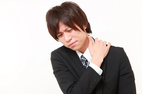 Young Japanese businessman suffers from neck ache　 — Stock Photo, Image