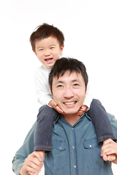 Japanese father giving his son piggy back — Stock Photo, Image