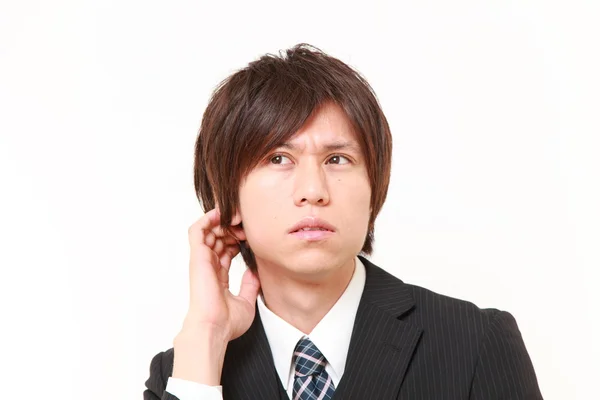 Young Japanese businessman worries about something — Stock Photo, Image