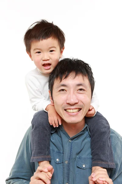 Japanese father giving his son piggy back — Stock Photo, Image