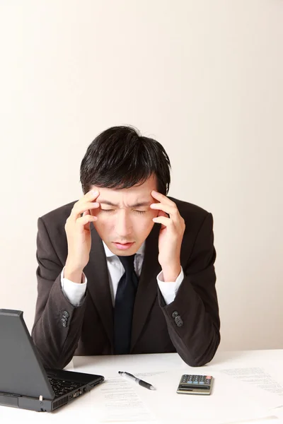 Businessman suffers from headache or Asthenopia — Stock Photo, Image