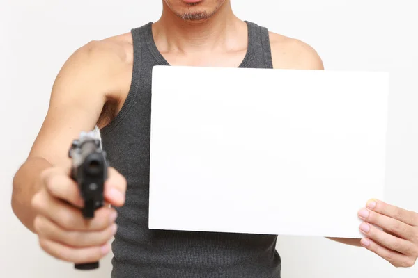 Man with a message board threatens by a gun — Stock Photo, Image