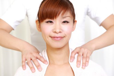 Young Japanese woman getting a shoulder massage　