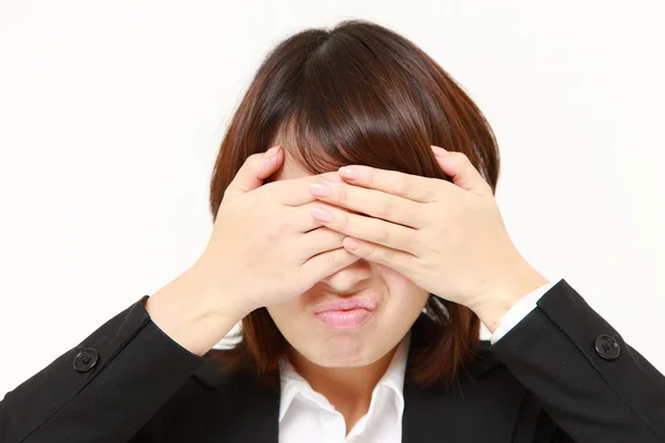 Portrait of covering her face with hands against white background — Stock Photo, Image