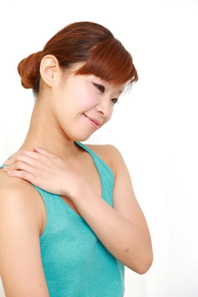 Young woman doing self shoulder massage — Stock Photo, Image