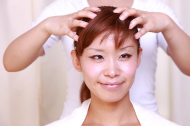 Young Japanese woman getting a head massage　